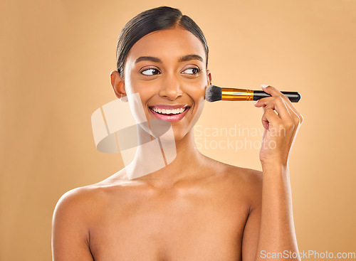 Image of Indian woman, beauty and brush for makeup with smile, cosmetic tools, skin glow and face on studio background. Happy female, thinking and cosmetology, apply foundation or powder with self care