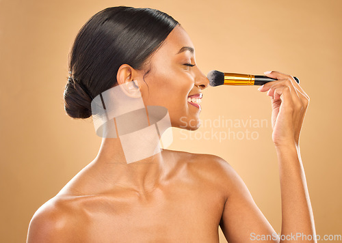 Image of Indian woman, beauty and brush for makeup, happy with cosmetic tools and glow and face profile on studio background. Female, smile and cosmetology, apply foundation or powder with self care