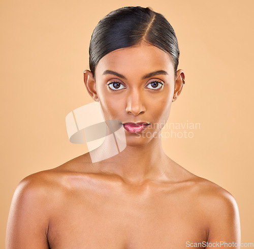 Image of Beauty, face and portrait of woman in studio for skincare, cosmetics, dermatology or makeup. Aesthetic female .serious about self care, natural skin and spa facial shine results on a brown background