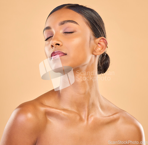 Image of Beauty, face and skin of woman in studio for skincare, cosmetics, dermatology or makeup. Aesthetic female .eyes closed for self care, natural shine and spa facial results on a brown background
