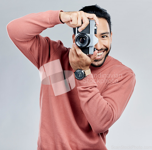 Image of Man with camera, photography in portrait with smile, taking picture with art and smile isolated on studio background. Photographer, happiness and creativity with vintage technology with creative male