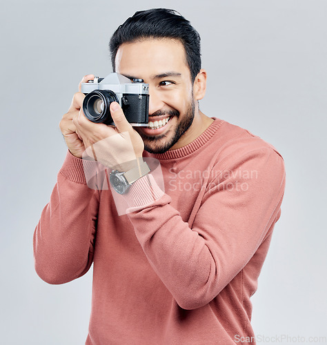 Image of Man with camera, photography and happy with smile, taking picture with art isolated on studio background. Photographer, happiness and creativity with vintage technology with creative male artist