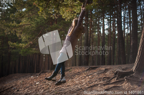 Image of Woman at bungee in autumn forest