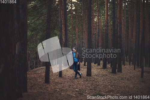 Image of Pretty happy woman in forest