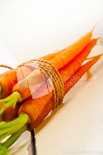 Image of baby carrots bunch tied with rope