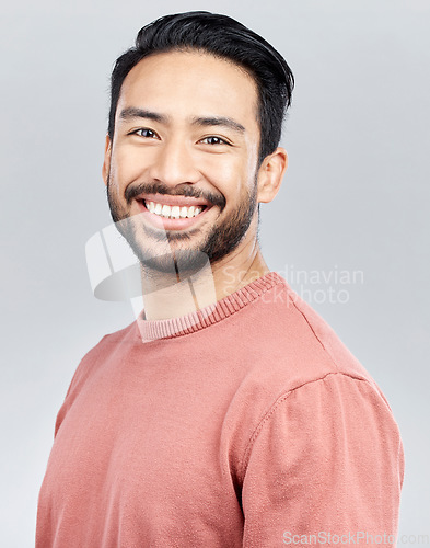 Image of Portrait, smile and happy Asian man in studio isolated on a gray background or backdrop. Face, fashion and young, confident and handsome male model from Singapore smiling, joy and positive mindset.