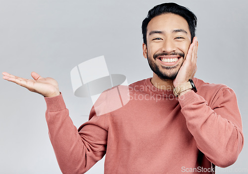 Image of Space, happy and a portrait of Asian man showing mockup isolated on a white background. Excited, promotion and guy gesturing for branding, advertising and marketing in studio with mock up backdrop