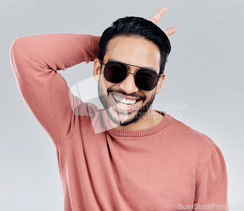 Image of Cool, funny and funky Asian man with sunglasses isolated on a white background in a studio. Portrait, comic and a laughing stylish Chinese guy with fashionable eyewear and crazy gesture on a backdrop