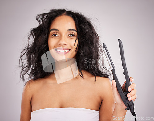 Image of Portrait, happy woman and hair straightener for beauty in studio, transformation or smile on background. Female model, haircare and heat styling equipment of ironing curly hairstyle, texture or tools