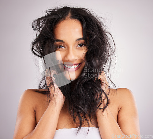 Image of Hair care, woman and beauty with portrait, cosmetics and happy with messy hairstyle on studio background. Wellness, shine and female smile, face and treatment, keratin and texture with volume