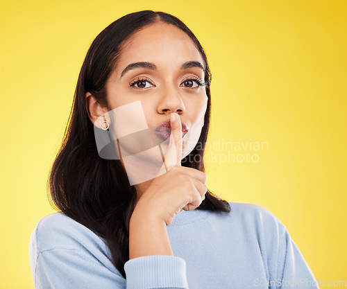 Image of Secret, portrait and woman with finger on lips in studio, yellow background and privacy sign. Face of female model, silence and shush for quiet, gossip and whisper emoji for confidential mystery news