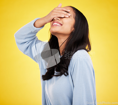 Image of Happy, hands cover eyes and woman with smile in yellow studio for positive mindset, happiness and freedom. Fashion, mockup space and isolated girl with hand on face for surprise, emoji and reaction