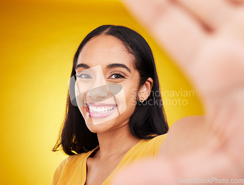 Image of Happy, smile and selfie with woman in studio for social media, confidence and picture. Photo, happiness and relax with portrait of female on yellow background for beauty, self care and influencer