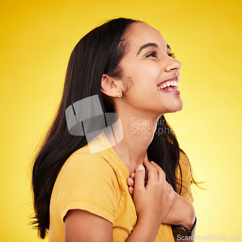 Image of Woman laugh, profile and studio with a excited young model happy with casual fashion. Isolated, yellow background and gen z, student and female person with a smile feeling happiness and surprise