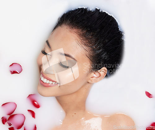 Image of Beauty, milk and rose petals with woman in bath for spa treatment, relax and skincare. Wellness, cosmetics and pampering with female and flowers from top view for grooming, satisfaction and self care