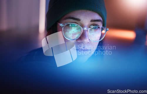 Image of Cybersecurity, database and woman hacker working on a computer in the basement at night for phishing. Malware, password and ransomware with a female coder hacking a digital transformation network