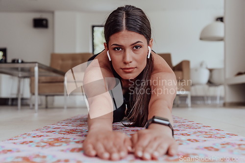 Image of Young Beautiful Female Exercising, Stretching and Practising Yoga with Trainer via Video Call Conference in Bright Sunny House. Healthy Lifestyle, Wellbeing and Mindfulness Concept.