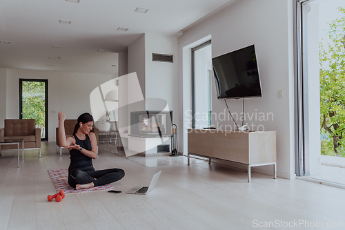 Image of Young Beautiful Female Woman with Trainer via Video Call Conference in Bright Sunny House. Healthy Lifestyle, Wellbeing and Mindfulness Concept.