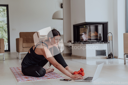 Image of Young Beautiful Female Woman with Trainer via Video Call Conference in Bright Sunny House. Healthy Lifestyle, Wellbeing and Mindfulness Concept.