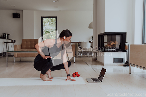 Image of Young Beautiful Female Woman with Trainer via Video Call Conference in Bright Sunny House. Healthy Lifestyle, Wellbeing and Mindfulness Concept.