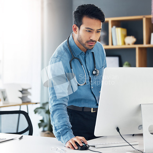 Image of Serious, man doctor and computer research, healthcare innovation and planning online. Medical worker, desktop technology and reading data of test results, wellness management and telehealth database