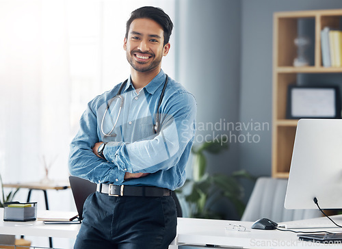 Image of Portrait, man and doctor with arms crossed in medical office, motivation or trust. Happy male healthcare worker, employee and expert of wellness management, happiness and commitment to pride or smile