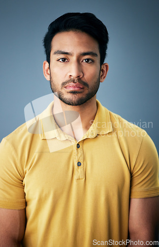 Image of Confidence, serious and portrait of a man in studio with depression, sadness or mental health problem. Tired, exhausted and Indian male model with burnout face expression isolated by gray background.