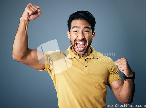 Image of Indian man, celebration fist and studio portrait for winning mindset, happiness or achievement by background. Young model, male student and celebration with happy, excited face or winning by backdrop