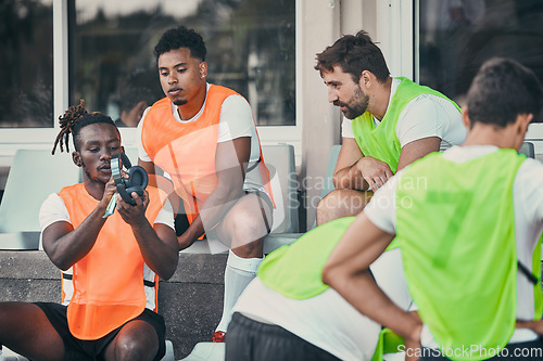 Image of Men, relax or rugby team with headphones on break, exercise workout or training for a game. Music, friends relaxing or sports people bonding, talking or resting after practice match on bench together