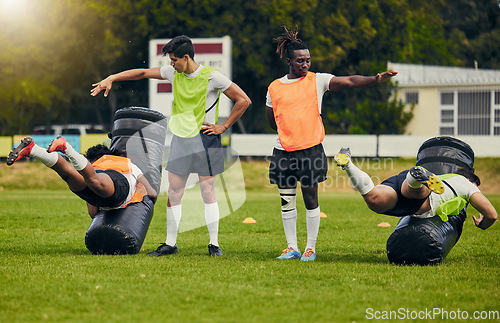 Image of Rugby, tackle and men training on field with equipment ready for match, practice and sport games. Fitness, teamwork and male athletes for warm up performance, exercise and workout for competition