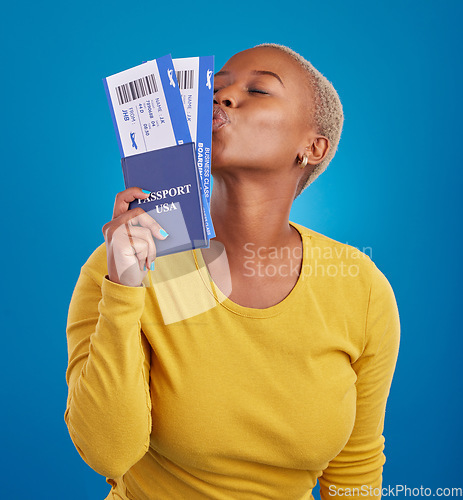 Image of Kiss, travel passport and black woman in studio on blue background for flight documents, tickets and ID. Traveling mockup, happy and girl celebrate immigration, USA holiday and international vacation