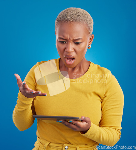 Image of Tablet, confused and what of woman shocked on stock market crash, risk or online mistake isolated on blue background. Stress, angry and frustrated person on digital technology for app error in studio