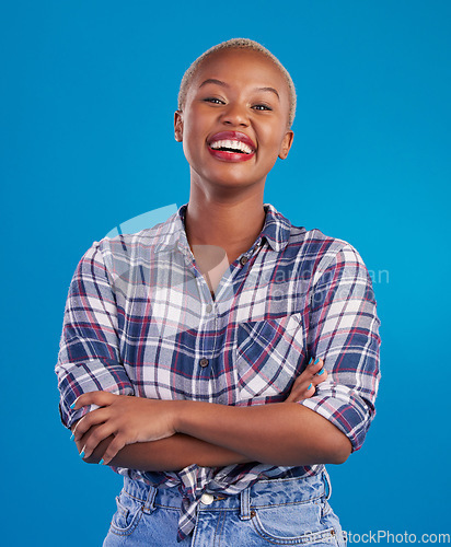 Image of Smile, crossed arms and portrait of black woman with happy mindset, proud and empowerment in studio. Fashion, beauty and attractive girl on blue background with wellness, happiness and motivation