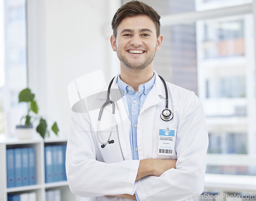 Image of Smile, doctor and portrait of man in hospital with crossed arms for wellness, medicine and medical care. Healthcare, insurance and happy health worker in clinic for consulting, trust and stethoscope