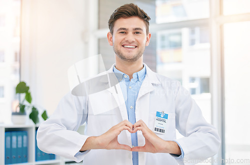 Image of Hands in heart, doctor and portrait of man in hospital with sign for wellness, medicine and medical care. Healthcare, insurance and happy worker in clinic for consulting, trust and cardiology support