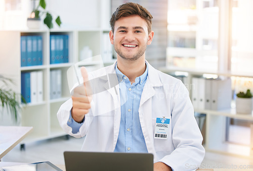 Image of Thumbs up, doctor and portrait of man in hospital office with laptop for wellness, telehealth and medical research. Healthcare, hand emoji and happy health worker for consulting, yes sign and support