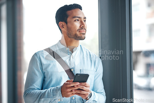 Image of Phone, thinking and man by office window for career inspiration, job search or online networking. Contemplating asian person or young entrepreneur cellphone, smartphone or mobile app in workplace