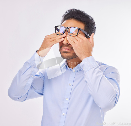 Image of Man in studio with glasses, rubbing eyes for vision, eyesight and tired on isolated on white background with burnout. Fatigue, stress and exhausted Indian businessman with prescription lens in frames