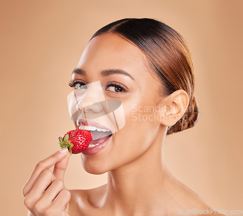 Image of Skincare portrait, eating or woman with strawberry in studio on beige background for healthy nutrition or clean diet. Healthcare, face or beautiful girl model or marketing natural fruits for wellness