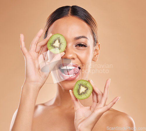 Image of Skincare, kiwi and portrait of woman with smile in studio for wellness, organic facial and natural cosmetics. Beauty, dermatology spa and happy face girl with fruit for detox, vitamin c and nutrients