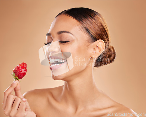 Image of Beauty, skincare or happy woman with strawberry in studio on beige background for healthy nutrition or clean diet. Smile, face or funny girl model laughing or marketing natural fruits for wellness