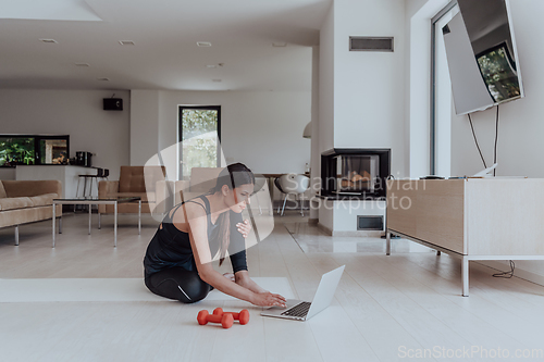 Image of Young Beautiful Female Woman with Trainer via Video Call Conference in Bright Sunny House. Healthy Lifestyle, Wellbeing and Mindfulness Concept.