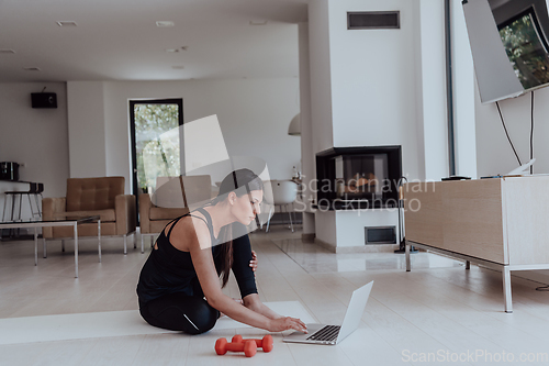 Image of Young Beautiful Female Woman with Trainer via Video Call Conference in Bright Sunny House. Healthy Lifestyle, Wellbeing and Mindfulness Concept.