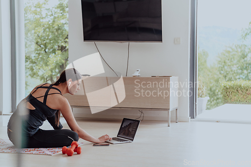 Image of Young Beautiful Female Woman with Trainer via Video Call Conference in Bright Sunny House. Healthy Lifestyle, Wellbeing and Mindfulness Concept.