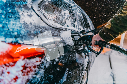 Image of Refuelling diesel gas on petrol station at winter