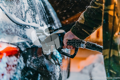 Image of Refuelling diesel gas on petrol station at winter