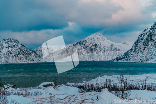 Image of Norway coast in winter with snow bad cloudy weather