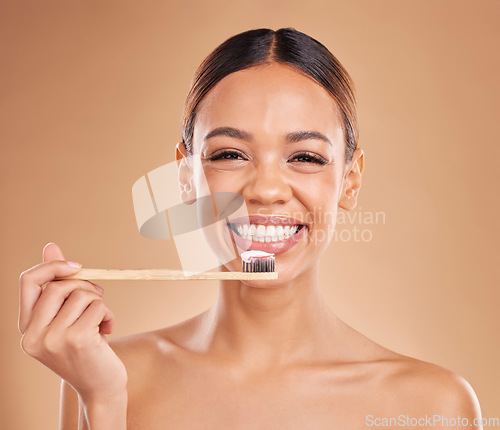 Image of Portrait, toothpaste or woman brushing teeth with product for healthy oral or dental hygiene in studio. Face, smile beauty or happy girl model cleaning mouth with a natural bamboo wooden toothbrush
