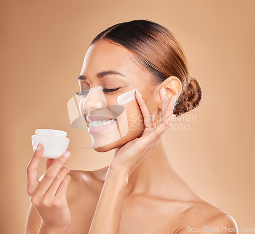 Image of Woman, skincare cream jar and studio for beauty, wellness or self care for face health by background. Girl, model and happy for cosmetic skin product for natural glow, collagen or dermatology benefit