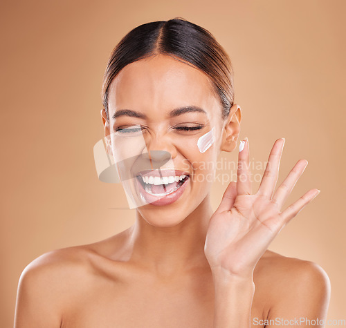 Image of Woman, skincare cream and smile in studio for beauty, wellness and excited face by background. Girl, young model and laugh with cosmetic skin product for natural glow, collagen or dermatology benefit